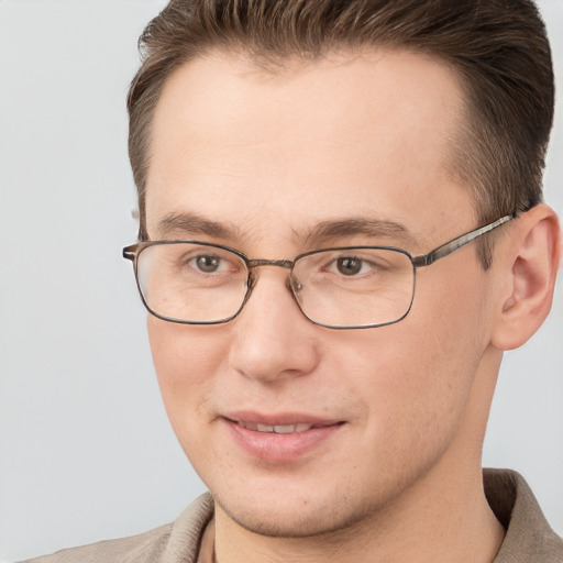 Joyful white adult male with short  brown hair and grey eyes