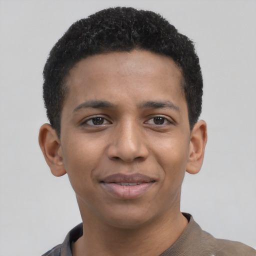 Joyful black young-adult male with short  black hair and brown eyes