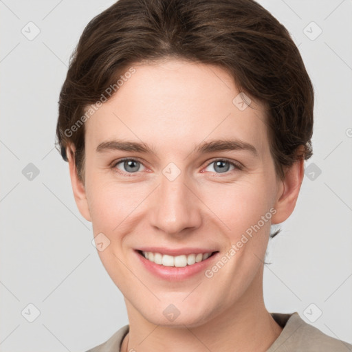 Joyful white young-adult female with short  brown hair and grey eyes