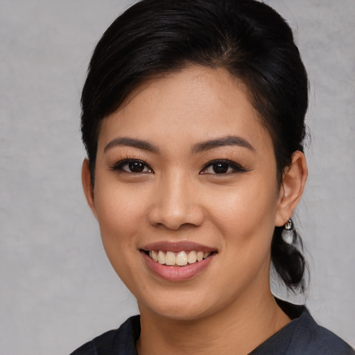 Joyful white young-adult female with medium  black hair and brown eyes