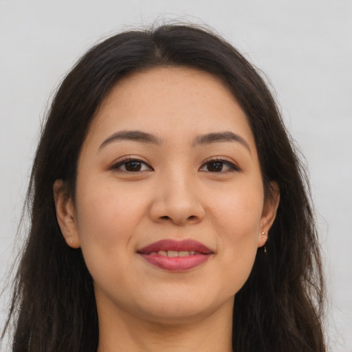 Joyful asian young-adult female with long  brown hair and brown eyes