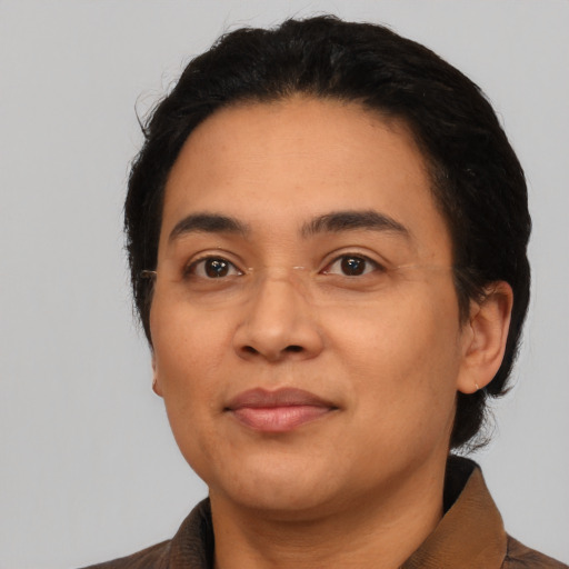 Joyful latino young-adult female with short  black hair and brown eyes