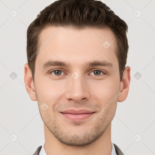 Joyful white young-adult male with short  brown hair and grey eyes