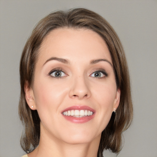 Joyful white young-adult female with medium  brown hair and blue eyes