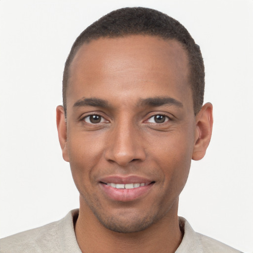 Joyful black young-adult male with short  brown hair and brown eyes