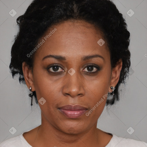 Joyful black adult female with short  brown hair and brown eyes