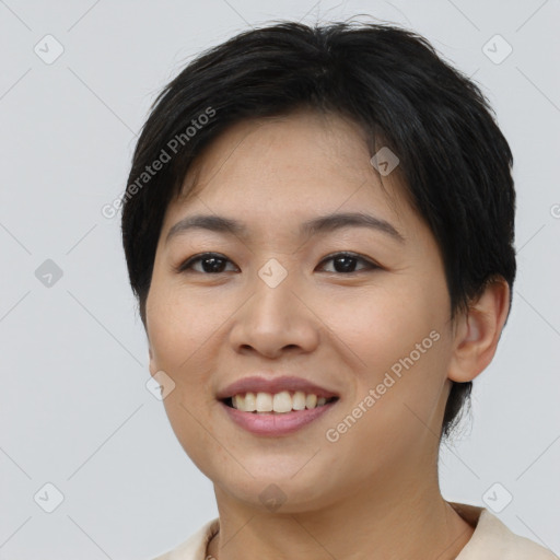 Joyful asian young-adult female with short  black hair and brown eyes