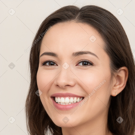 Joyful white young-adult female with long  brown hair and brown eyes