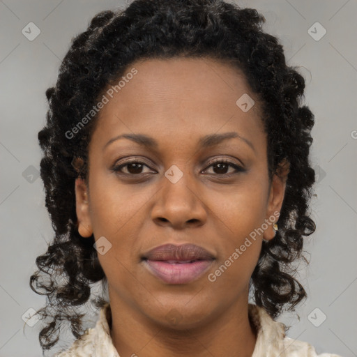 Joyful black young-adult female with long  brown hair and brown eyes