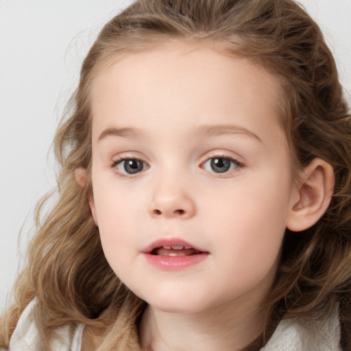 Joyful white child female with medium  brown hair and grey eyes