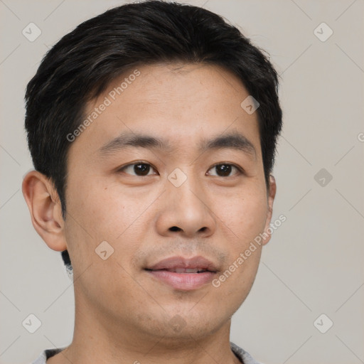 Joyful asian young-adult male with short  black hair and brown eyes