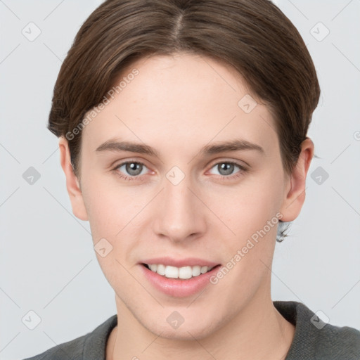 Joyful white young-adult female with short  brown hair and grey eyes