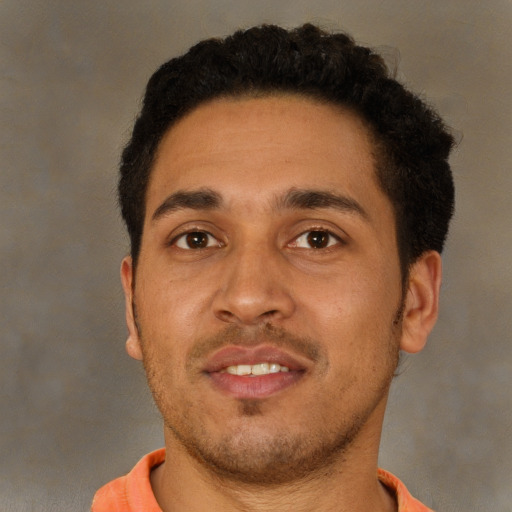 Joyful latino young-adult male with short  brown hair and brown eyes