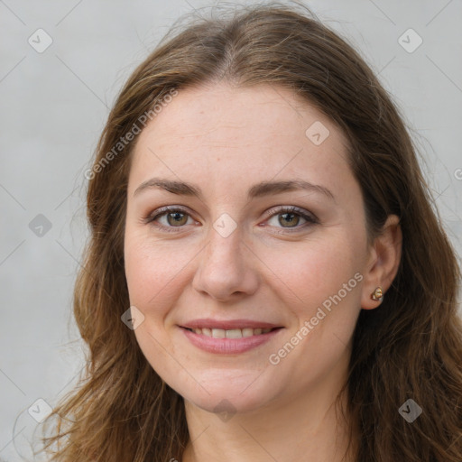 Joyful white young-adult female with long  brown hair and green eyes