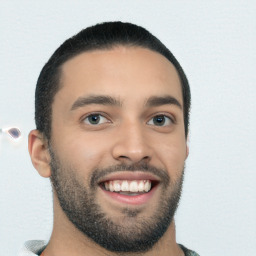 Joyful white young-adult male with short  black hair and brown eyes