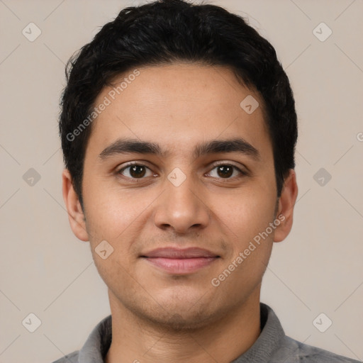 Joyful latino young-adult male with short  black hair and brown eyes