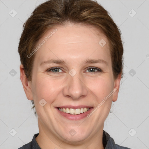 Joyful white adult female with short  brown hair and grey eyes