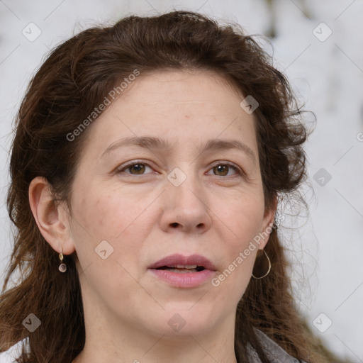 Joyful white adult female with long  brown hair and grey eyes