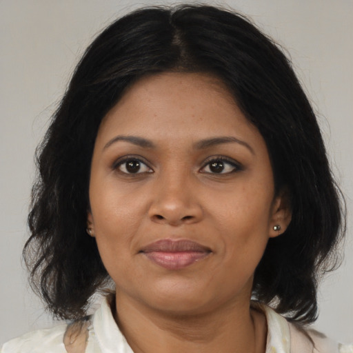 Joyful black young-adult female with medium  brown hair and brown eyes