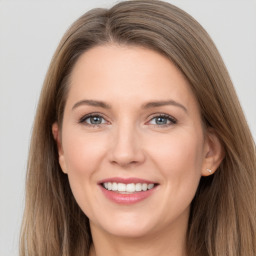 Joyful white young-adult female with long  brown hair and grey eyes