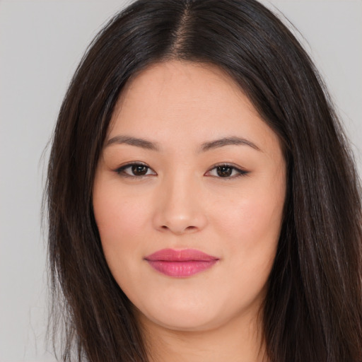 Joyful asian young-adult female with long  brown hair and brown eyes