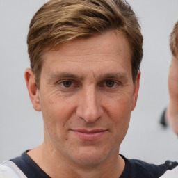 Joyful white adult male with short  brown hair and grey eyes