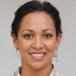 Joyful latino young-adult female with short  brown hair and brown eyes