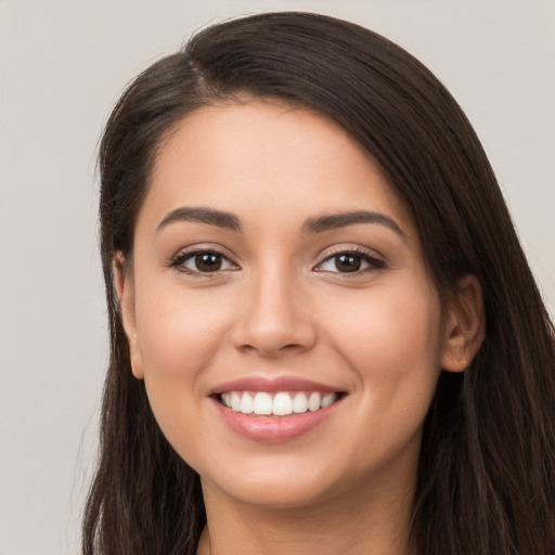 Joyful white young-adult female with long  brown hair and brown eyes