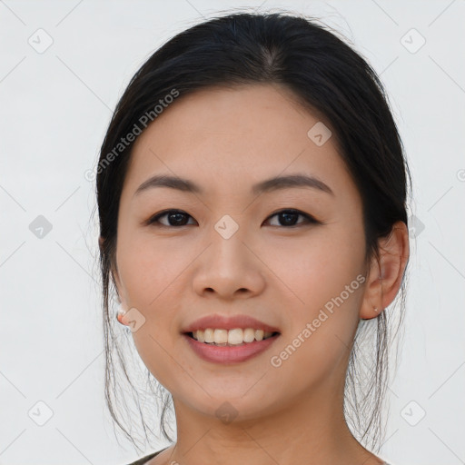 Joyful asian young-adult female with long  brown hair and brown eyes