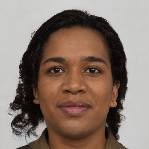 Joyful black young-adult female with medium  black hair and brown eyes