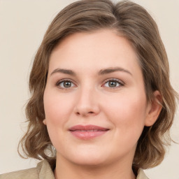 Joyful white young-adult female with medium  brown hair and green eyes