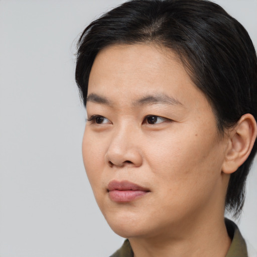 Joyful asian young-adult female with medium  black hair and brown eyes