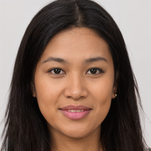Joyful asian young-adult female with long  brown hair and brown eyes