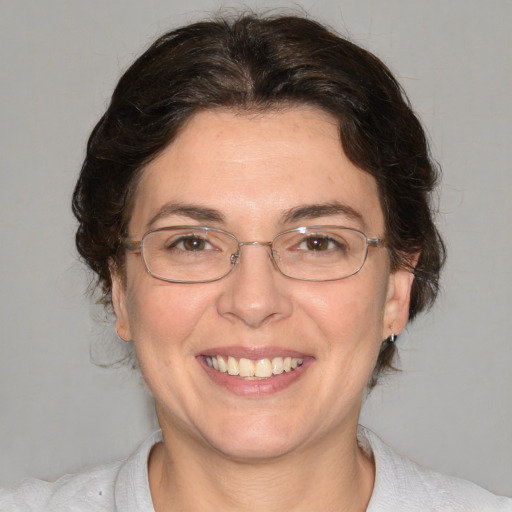 Joyful white adult female with medium  brown hair and brown eyes