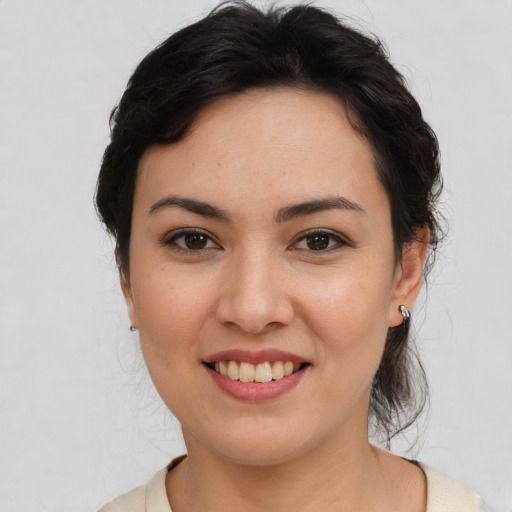 Joyful latino young-adult female with medium  brown hair and brown eyes