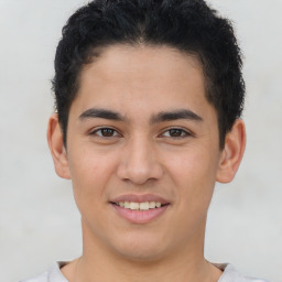 Joyful latino young-adult male with short  brown hair and brown eyes