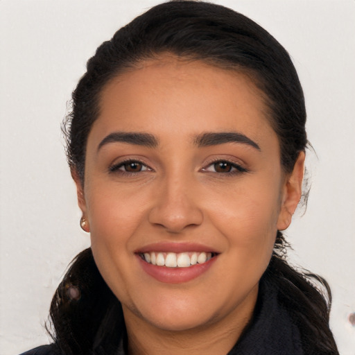 Joyful white young-adult female with long  black hair and brown eyes