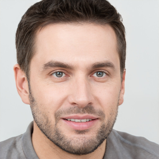 Joyful white young-adult male with short  brown hair and brown eyes