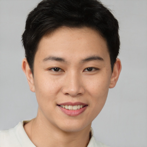 Joyful asian young-adult male with short  brown hair and brown eyes