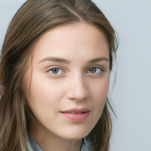 Joyful white young-adult female with long  brown hair and blue eyes