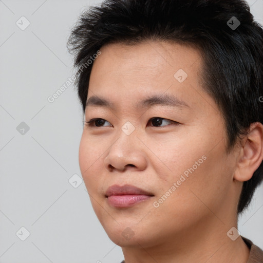 Joyful asian young-adult male with short  brown hair and brown eyes