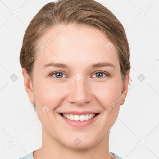 Joyful white young-adult female with short  brown hair and grey eyes