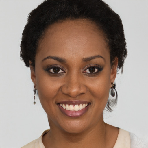 Joyful black young-adult female with short  black hair and brown eyes