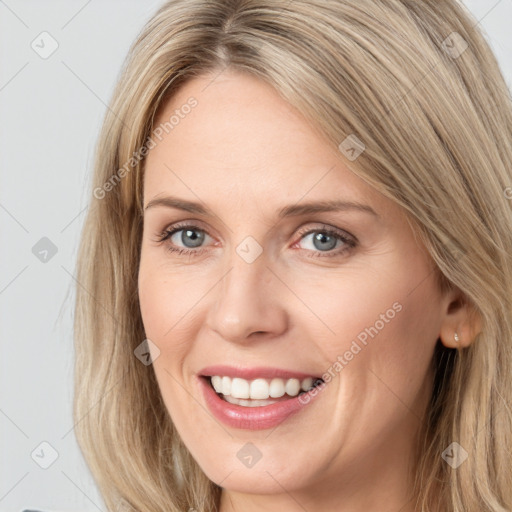 Joyful white young-adult female with long  brown hair and grey eyes