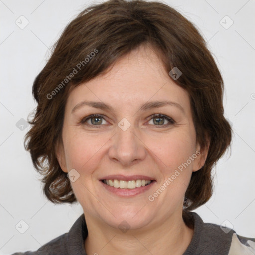 Joyful white adult female with medium  brown hair and grey eyes