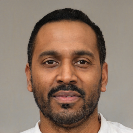 Neutral latino adult male with short  black hair and brown eyes