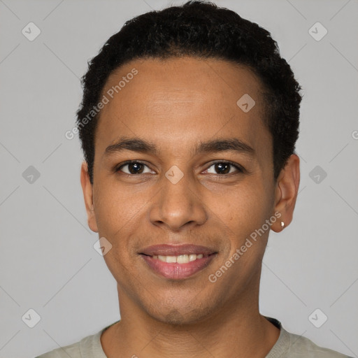 Joyful black young-adult male with short  black hair and brown eyes