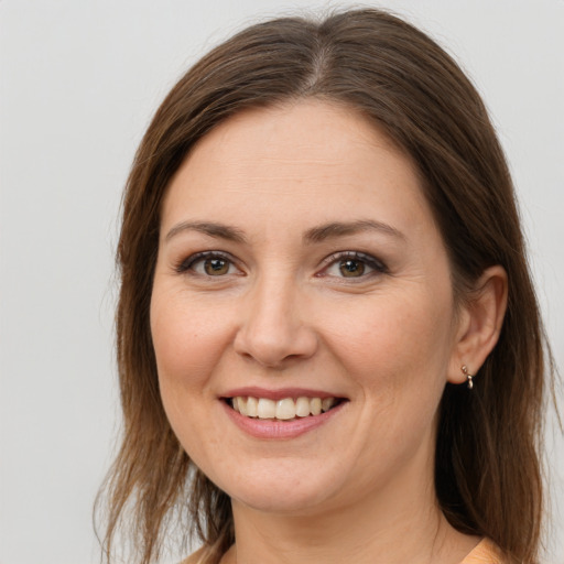 Joyful white young-adult female with long  brown hair and grey eyes