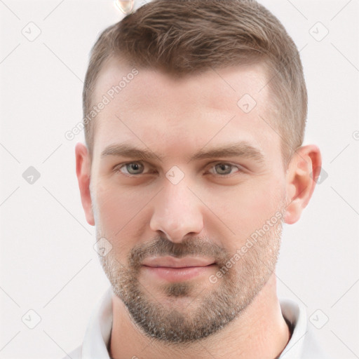 Joyful white young-adult male with short  brown hair and grey eyes