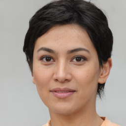 Joyful asian young-adult female with short  black hair and brown eyes